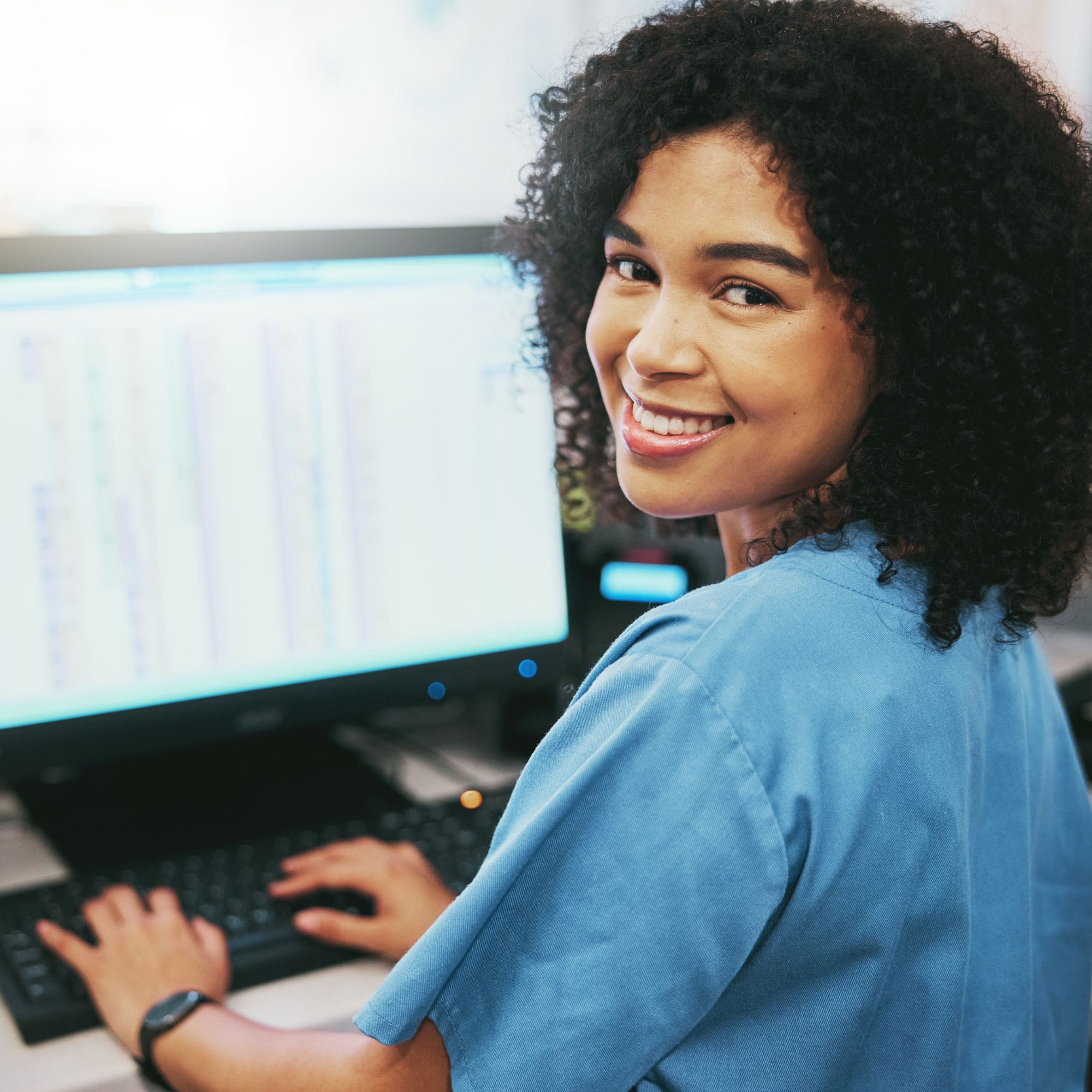 Female hospital employee working on computer