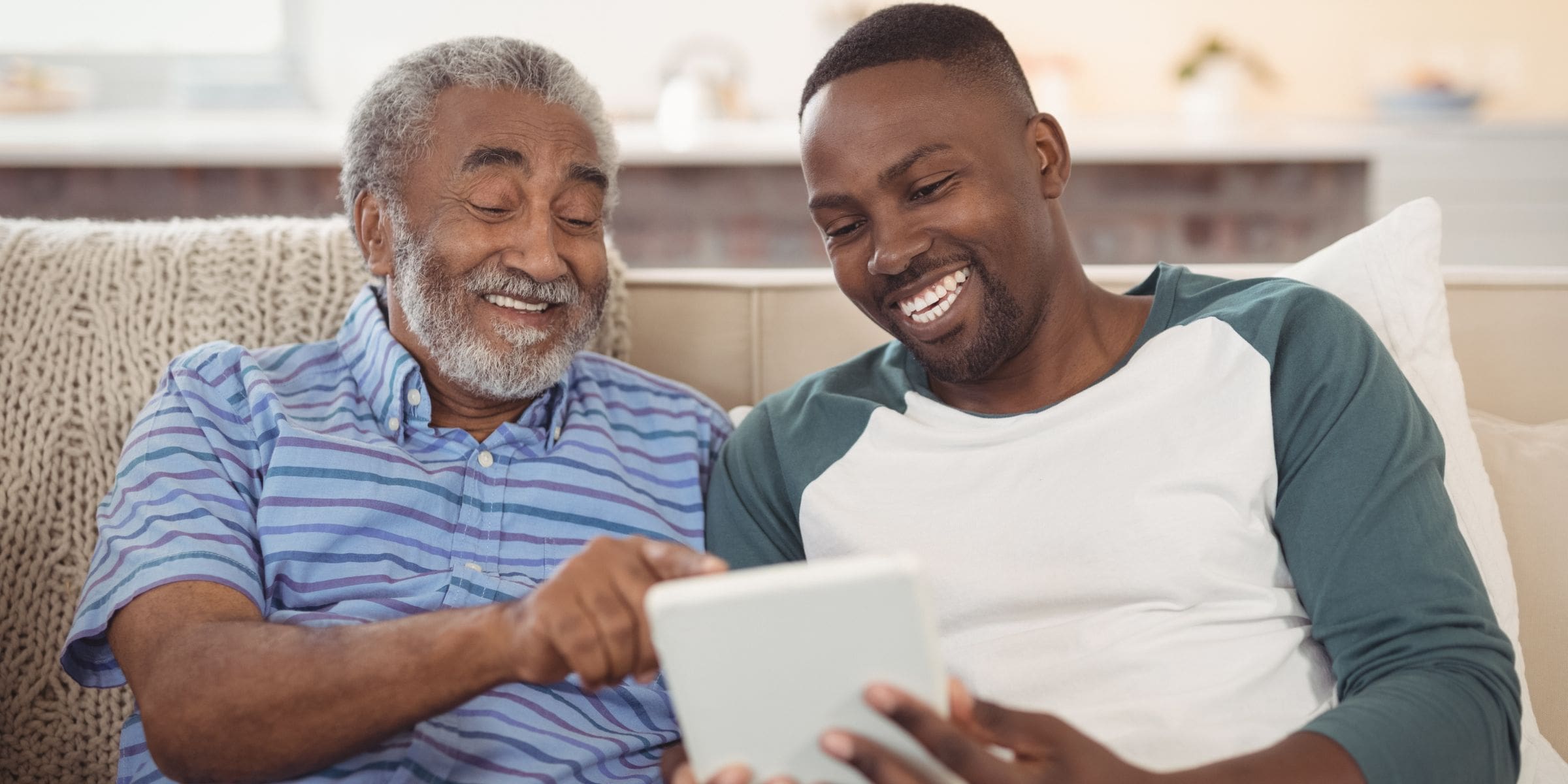 Two African American men looking at tablet